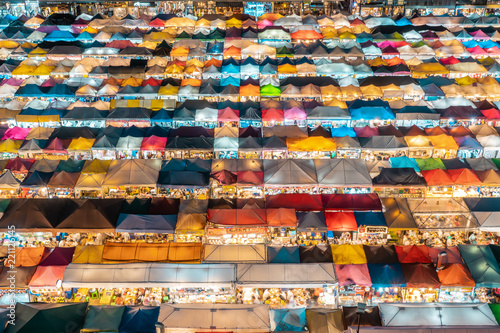 BANGKOK, THAILAND - AUGUST 12, 2018: Closeup aerial shot of market stalls in the famous Train Market in Bangkok © Daniel