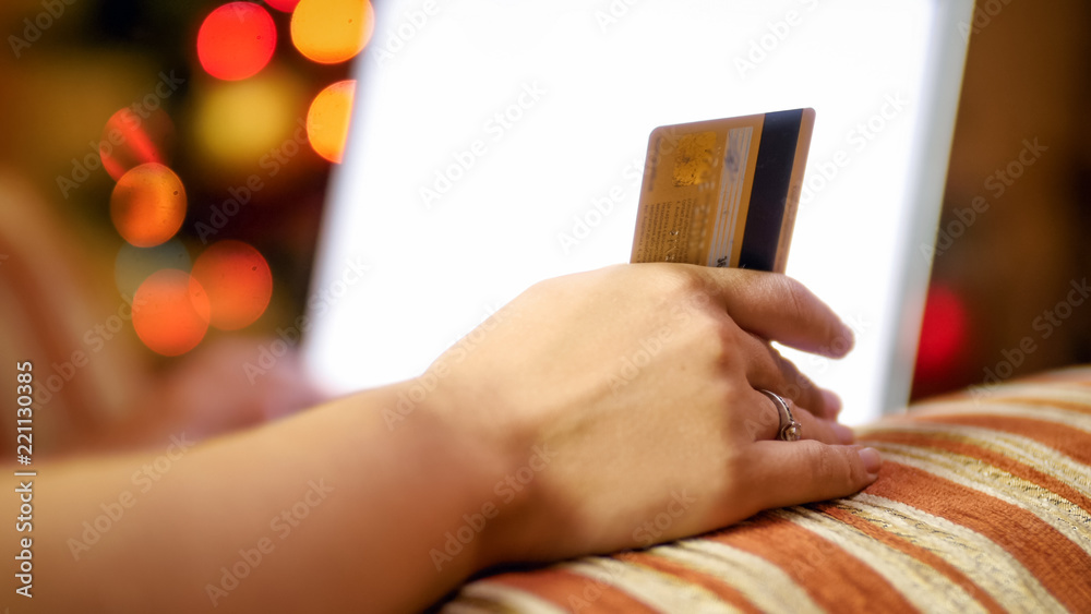 Closeup image of young woman using credit card to make purchases for ...