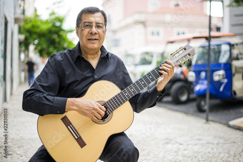Aoustic guitar player on the street of Alfama in Lisbon, Portugal photo