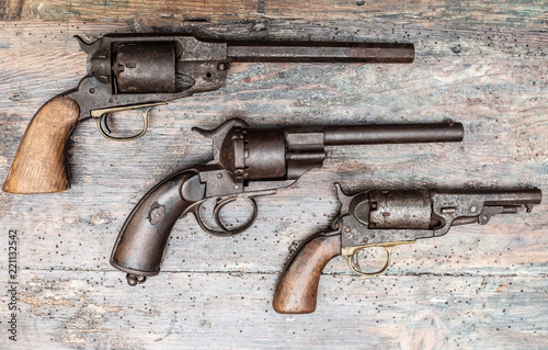 A historical pistols on vintage wooden table..