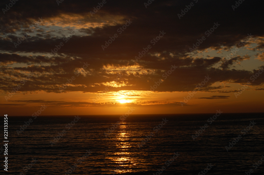 The sun setting over the sea, at California