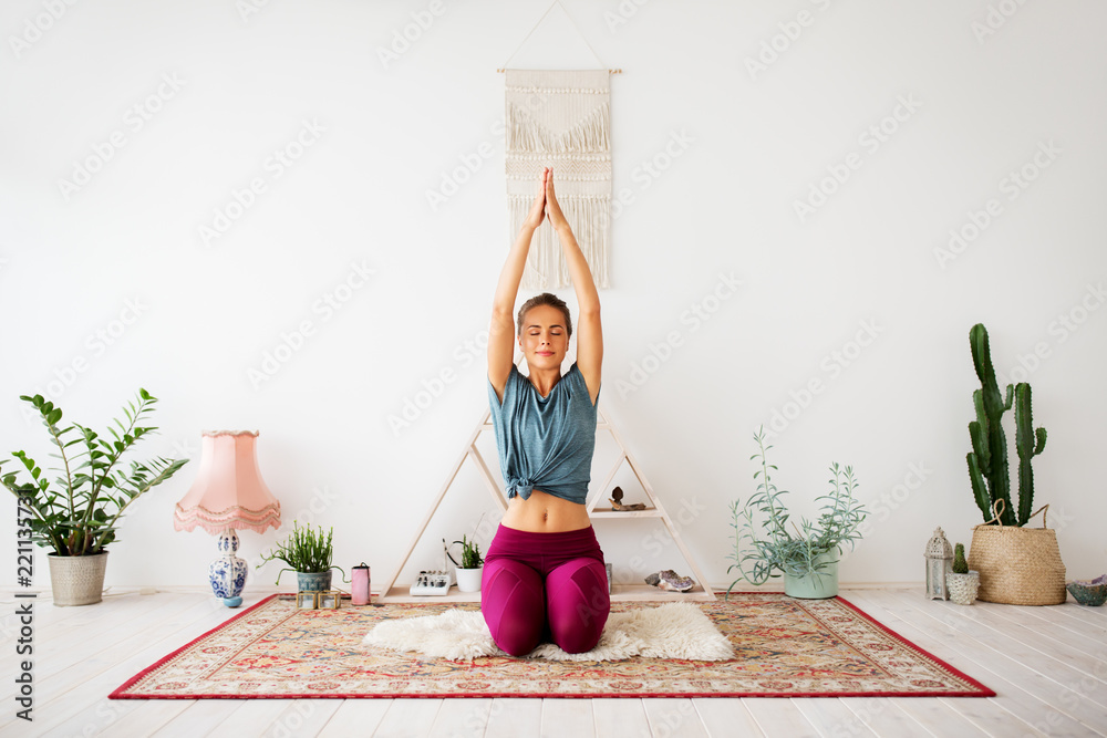 mindfulness, spirituality and healthy lifestyle concept - woman meditating at yoga studio - obrazy, fototapety, plakaty 