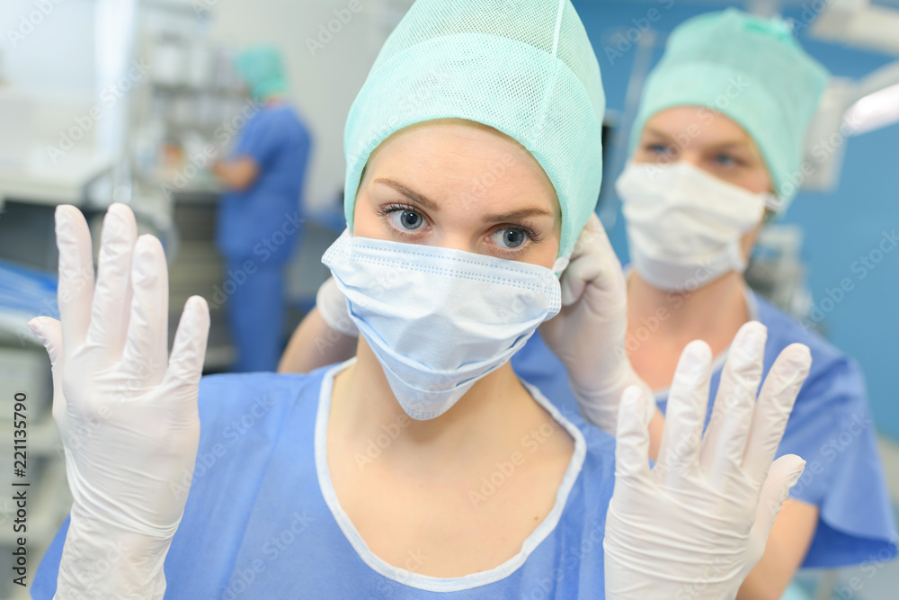 female surgeon in uniform getting ready for medical procedure surgery