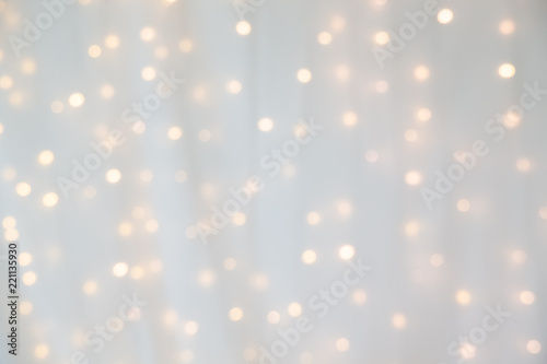bokeh of yellow led light under curtain.