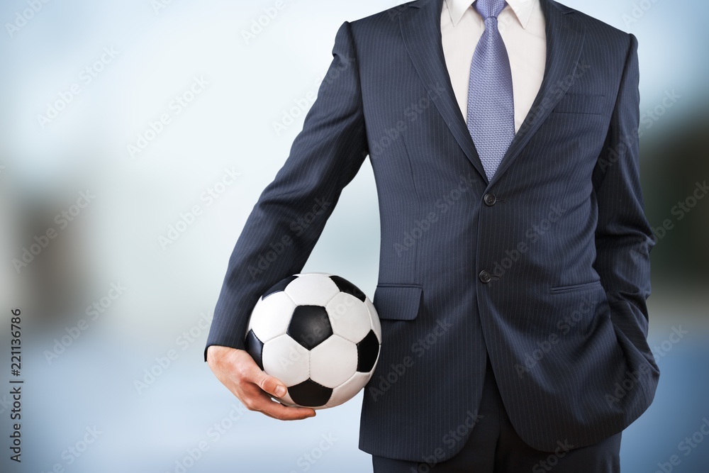 Close-up young male businessman holding Soccer ball Close-up young male businessman holding Soccer ball