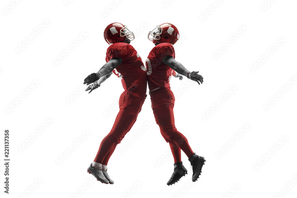 Active two american football player isolated on white background. Fit caucasian men in uniform with ball jumping over studio background in jump or motion. Human emotions and facial expressions concept