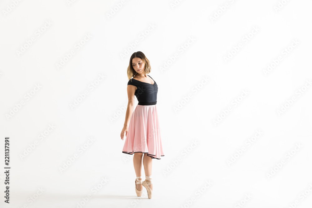 Ballerina Standing On Tiptoes While Rehearsing Over White Background Ballerina Standing On Tiptoes While Rehearsing Over White Background