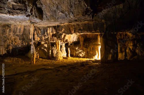 View of stalactites and stalagmites in an underground cavern - Postojna cave in Slovenia photo