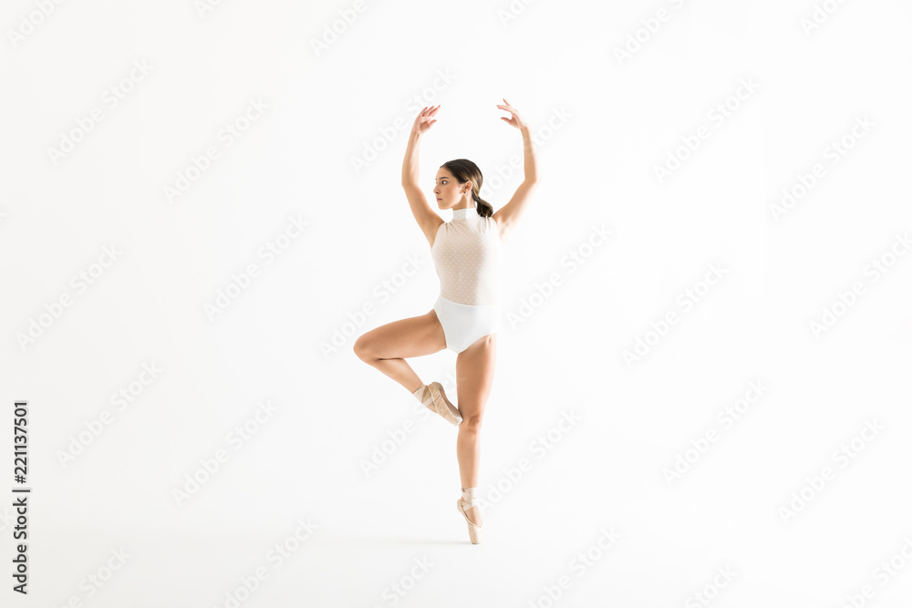 Obraz premium Ballerina Rehearsing On One Leg With Arms Raised