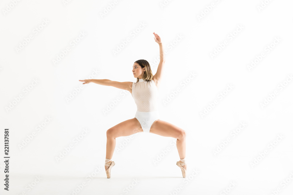 Energetic Female Dancer Performing Ballet Squat