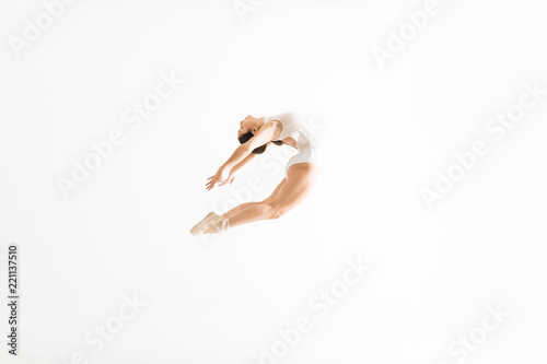 Fototapeta Naklejka Na Ścianę i Meble -  Ballet Dancer Performing High Jump And Backbend On White Background