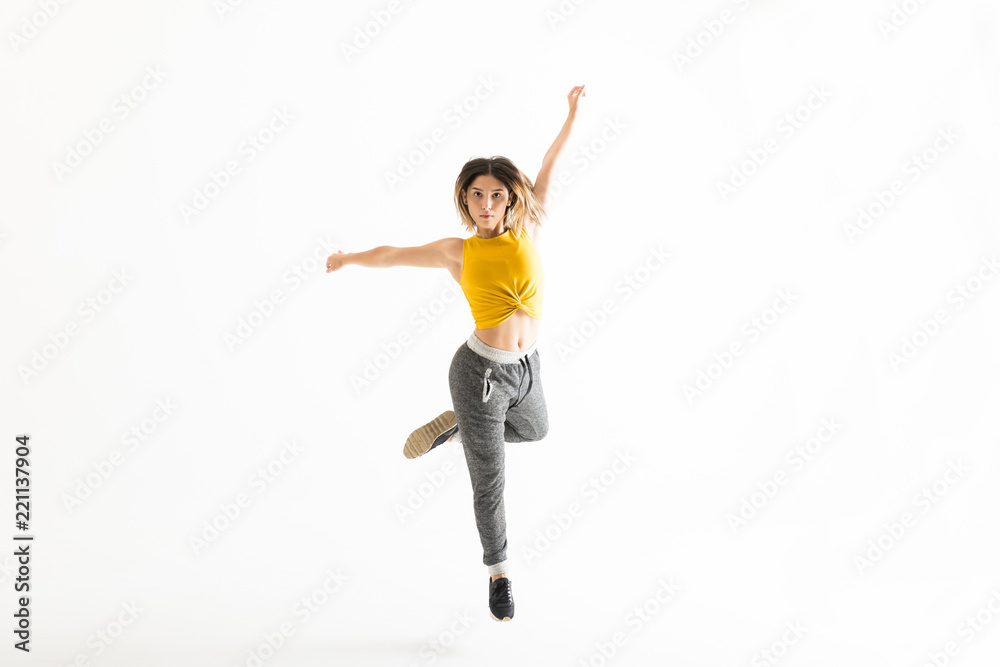 Obraz premium Fit Young Woman Dancing Over White Background