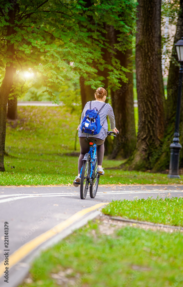 Girl riding a bike in the city Park 