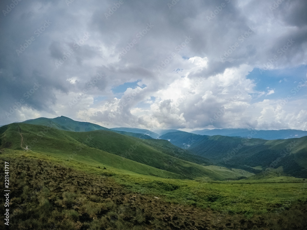 The summer green Carpathian mountains in Ukraine. The sky is over the mountains. Atmospheric landscapes while traveling on a jeep. Offroad expedition