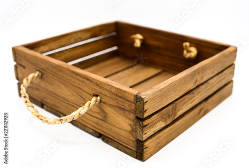 Empty retro dark brown wooden box with rope on white background