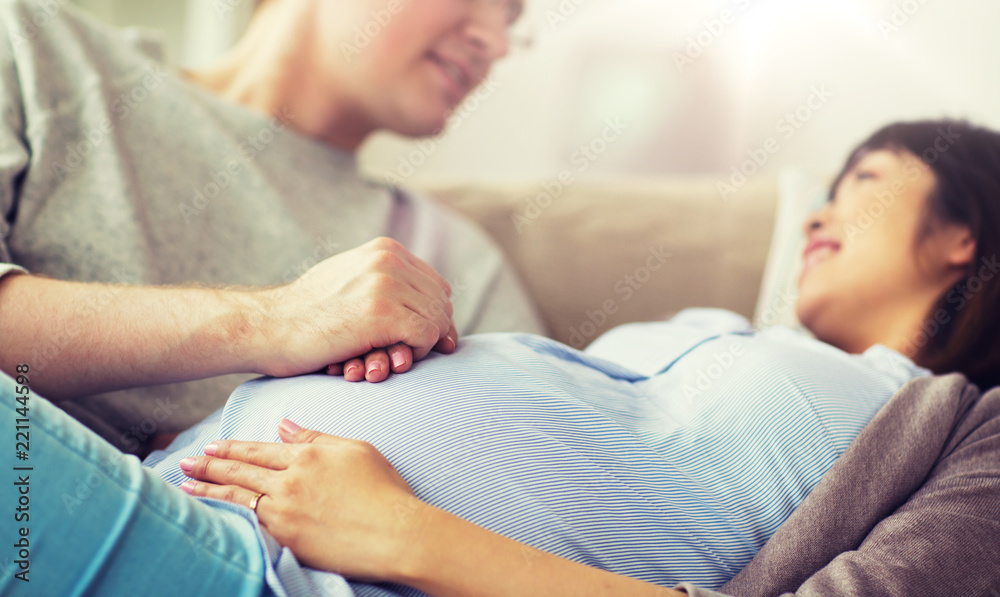 pregnancy, family and people concept - close up of man and pregnant woman pregnancy, family and people concept - close up of man and pregnant woman