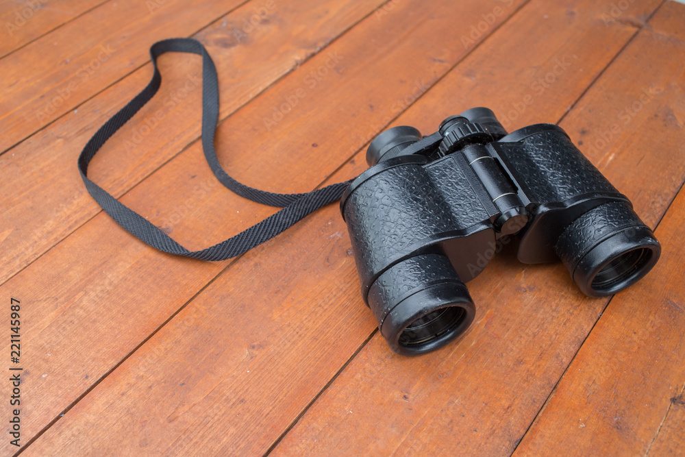 A pair of old binoculars on a table A pair of old binoculars on a table