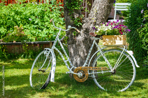 Picture of old vintage bicycle with flowers on the green grass