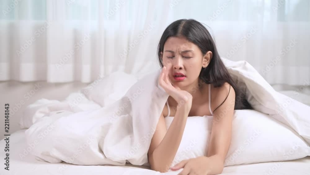 Worried woman in bed portrait. Asian woman lying in bed worry and thinking. Worried woman in bed portrait. Asian woman lying in bed worry and thinking.