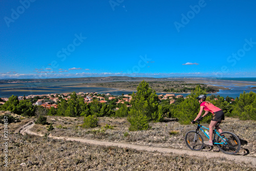 A girl enjoy her ride with the bike to the sea