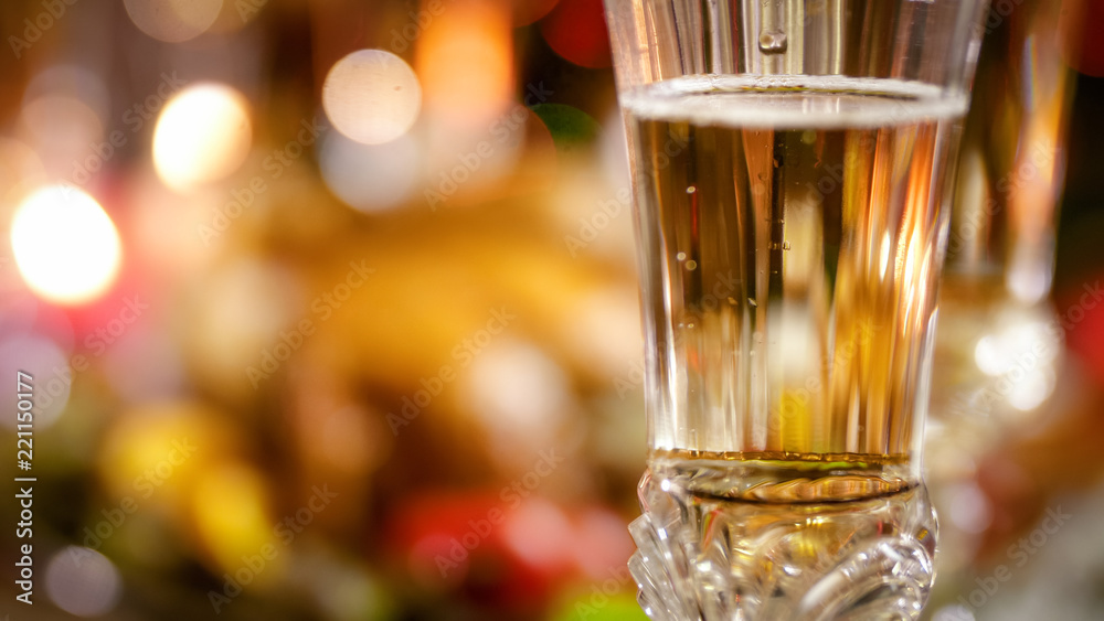 Closeup image of beautiful crystal glass with champagne on dining table