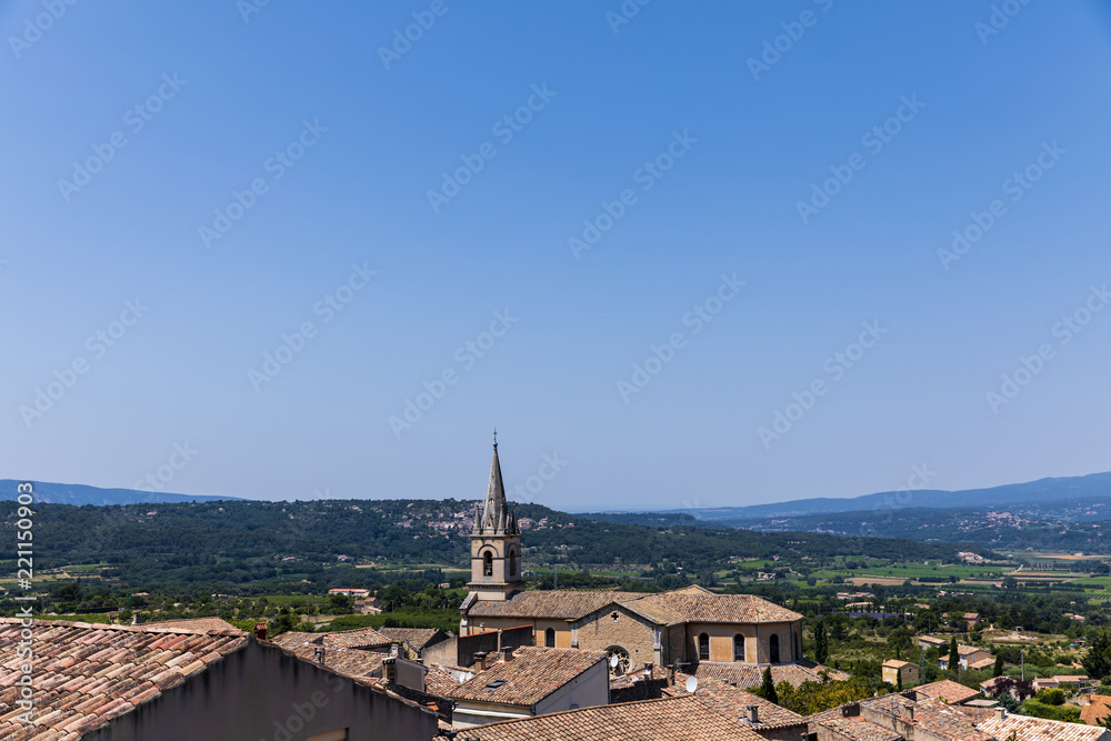 beautiful traditional architecture, roofs and distant mountains in Bonnieux, France