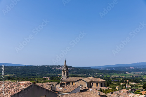 beautiful traditional architecture, roofs and distant mountains in Bonnieux, France