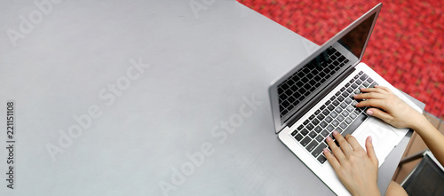 Website banner of laptop with female hands, copy space in grey color and red background. Concept of blog header and advertisement of bitcoin and cryptocurrency