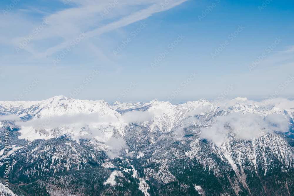 White snowy mountaon peaks. Sunny blue landscape in Austrian Alps. Clouds flying over the summits