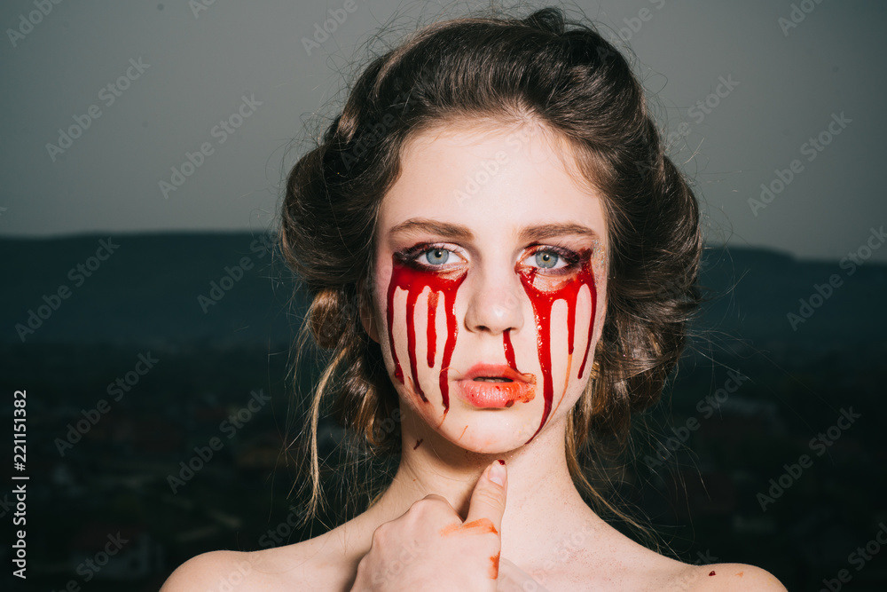 Naklejka premium bloody halloween. woman with blood eyes. happy halloween party. death and scary magic girl with blood tears on face. I love being witchy. bloody mary
