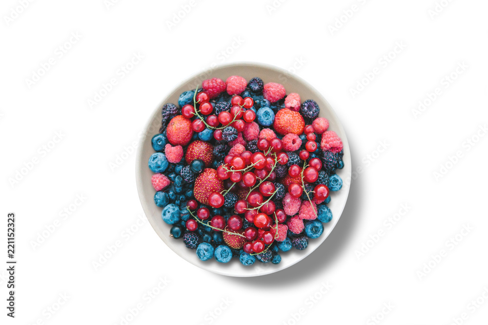 View from above. Various berries in a plate on a white background. View from above. Various berries in a plate on a white background.
