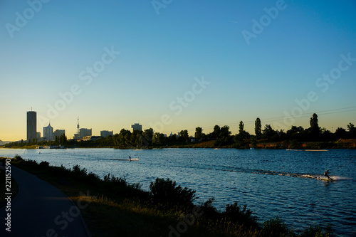 Photography Wakesurfing on Danube with sunset background and view on Wien