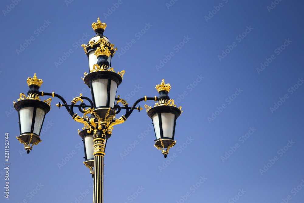 old-fashioned street lamp decorated by gold