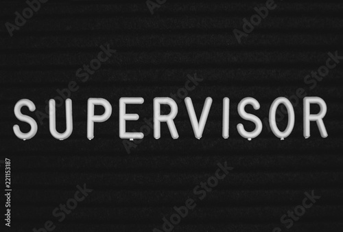 Word supervisor written on the letter board. White letters on the black background
