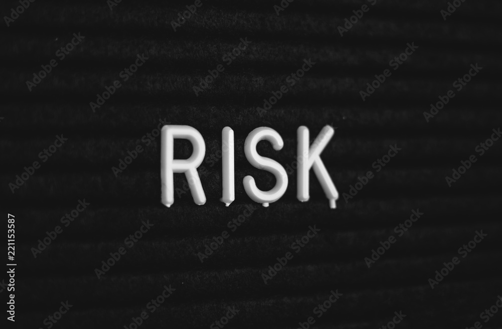 Word risk written on the letter board. White letters on the black background Word risk written on the letter board. White letters on the black background