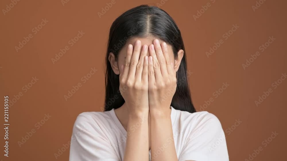 Girl playing hide and seek portrait. Asian woman in white t-shirt cover her eyes with her hands for hide and seek. Girl playing hide and seek portrait. Asian woman in white t-shirt cover her eyes with her hands for hide and seek.