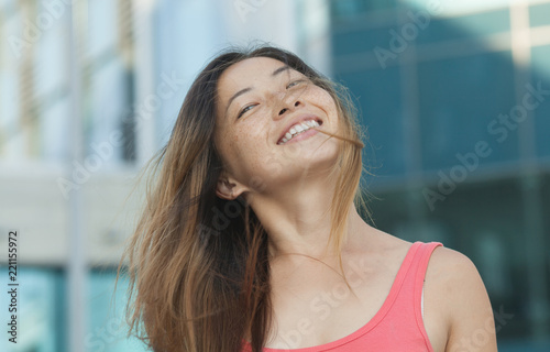 A portrait of a beautiful asian woman smiling brightly at the camera Free Download A portrait of a beautiful asian woman smiling brightly at the camera - GFXLoad