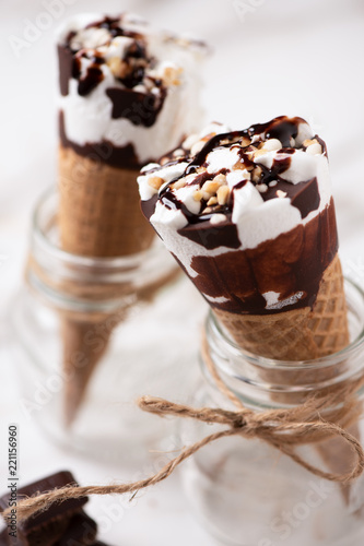 Two cornetto ice cream. Vanilla ice cream on wafle on white background photo