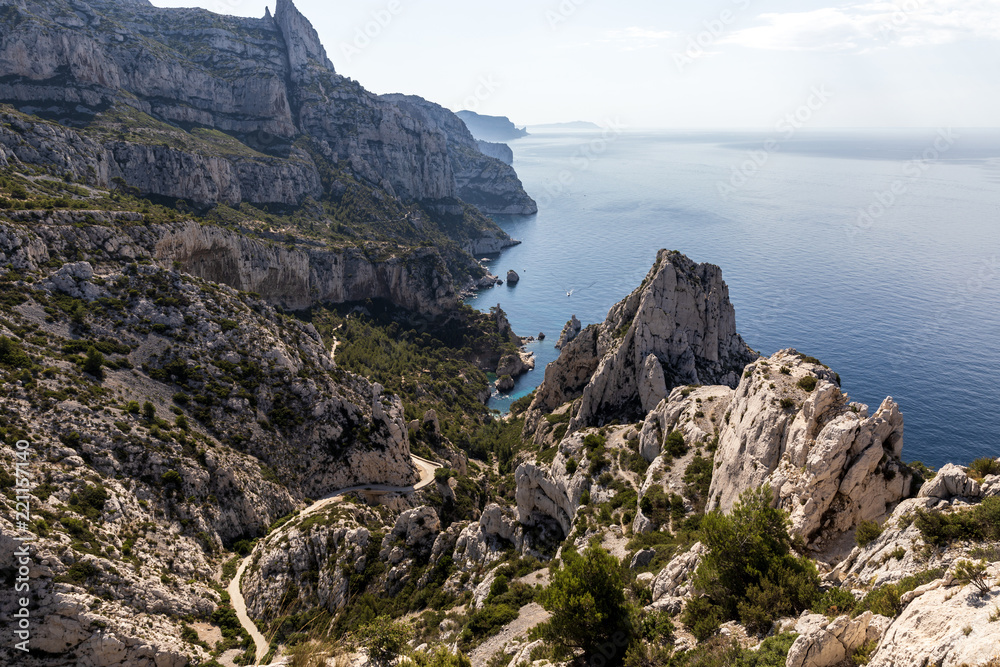 aerial view of winding road, cliffs and calm sea in Calanques de ...