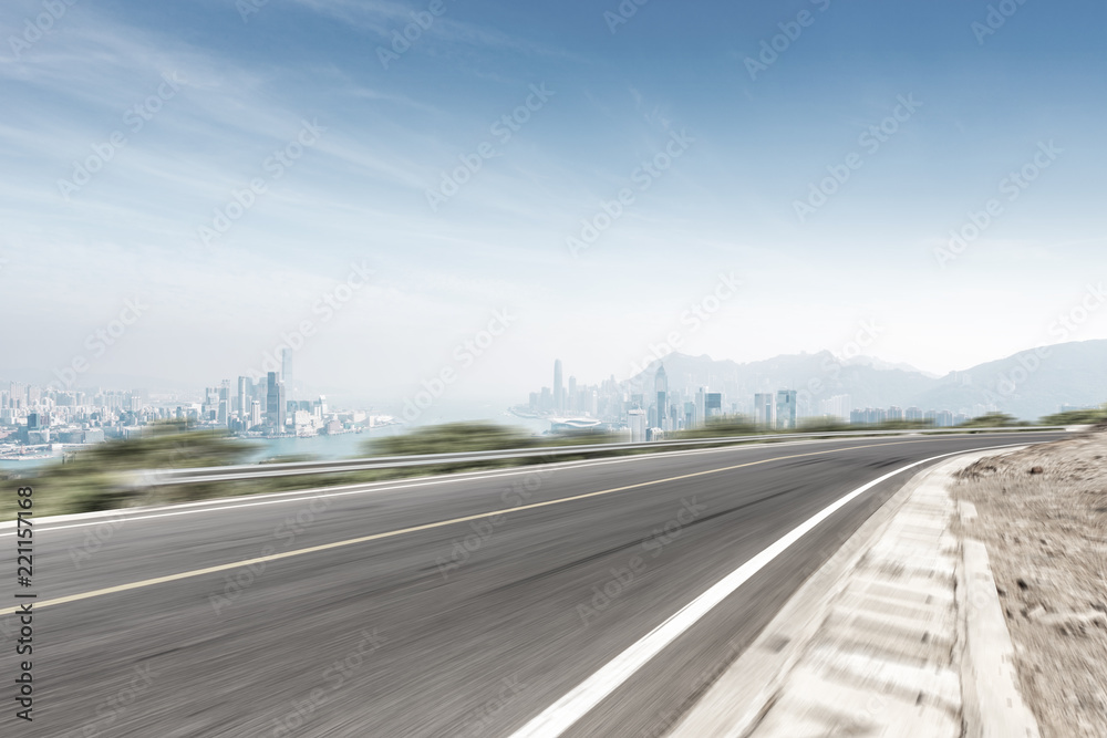 empty asphalt highway through modern city