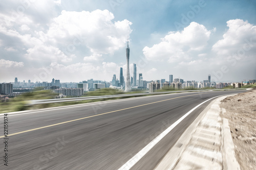 empty asphalt highway through modern city