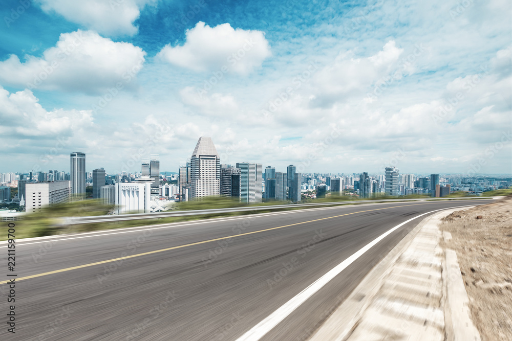 empty asphalt highway through modern city