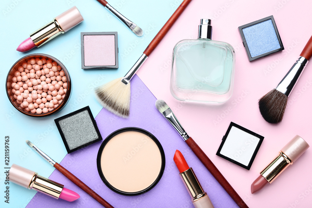Makeup cosmetics with perfume bottle on colorful background