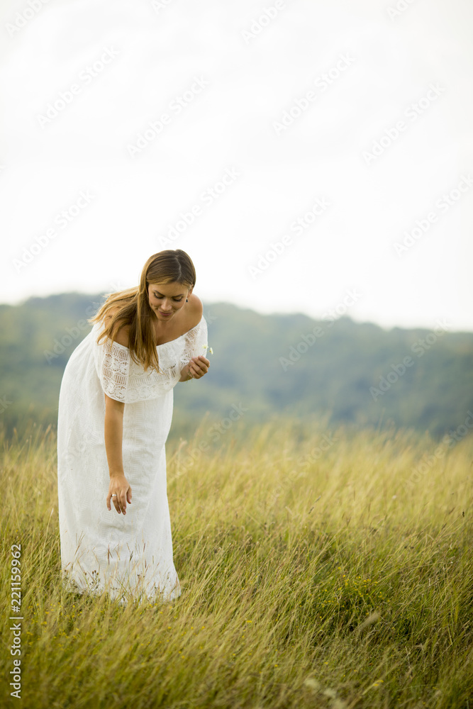 Young pregnant woman relaxing outside in nature Young pregnant woman relaxing outside in nature