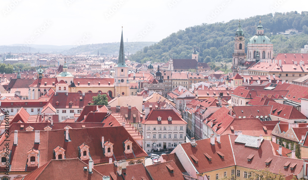 Landscape of the beautiful old city of Prague, Czech Republic on a bright sunny day. Red roofs of the tile in the old town. Beautiful historic city view from above.