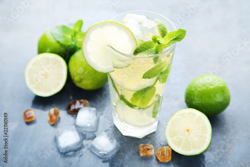 Mojito cocktail in glass with sugar on wooden table