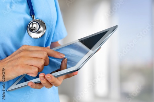 Close-up Doctor at hospital working with tablet pc photo