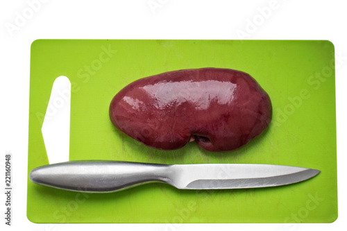 Fresh pork kidney on a cutting board. Fresh raw kidney for dog.