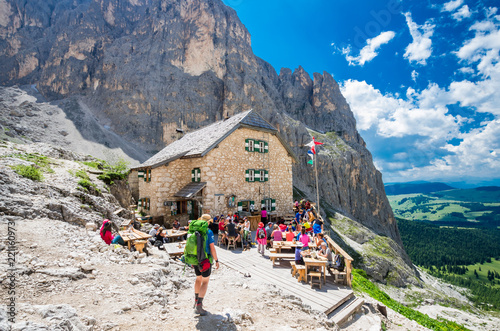 RIFUGIO VICENZA, SASSOLUNGO MASSIF, ITALY, JULY 1, 2018: Mountaineering people resting at Vicenza chalet in Dolomites mountains. photo