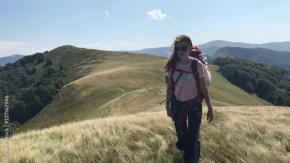 Young girl hikes on nature trail in mountain during summer. Young girl hikes on nature trail in mountain during summer.